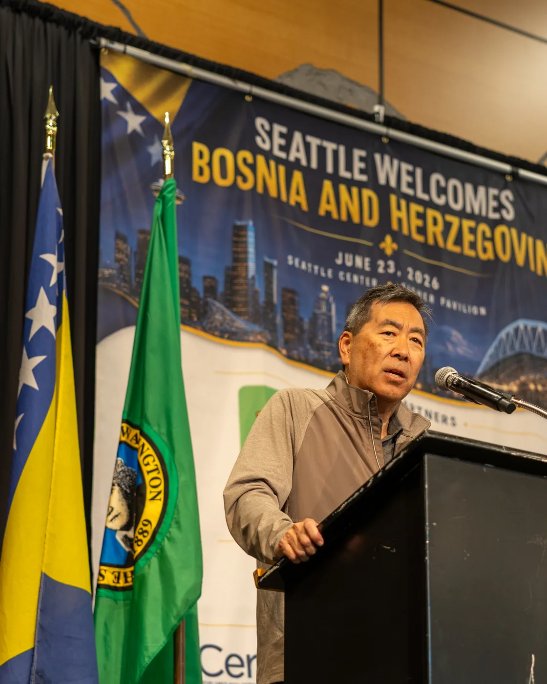Documentary event photography — speaker addressing the crowd at Seattle Welcomes Bosnia and Herzegovina